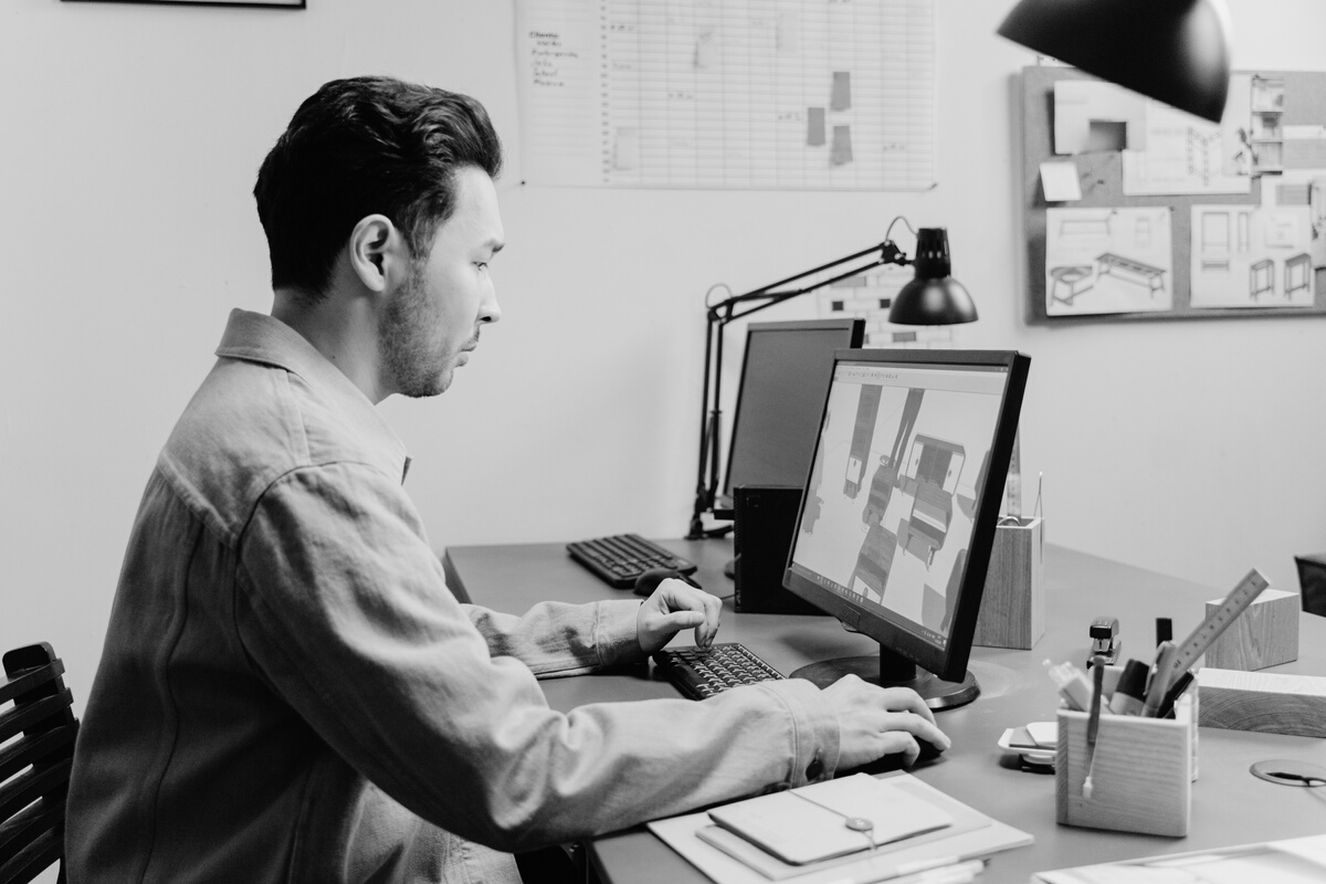 A Man in Brown Long Sleeves Using Computer